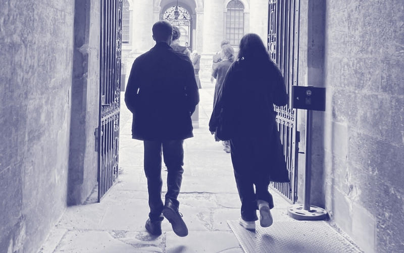 Two young people walking through an Oxford college gate into a courtyard, overlaid with purple Astrophoria Foundation Year graphics.