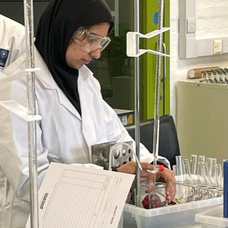 Chemistry student Nayab taking part in a practical