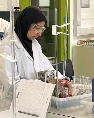 Chemistry student Nayab taking part in a practical