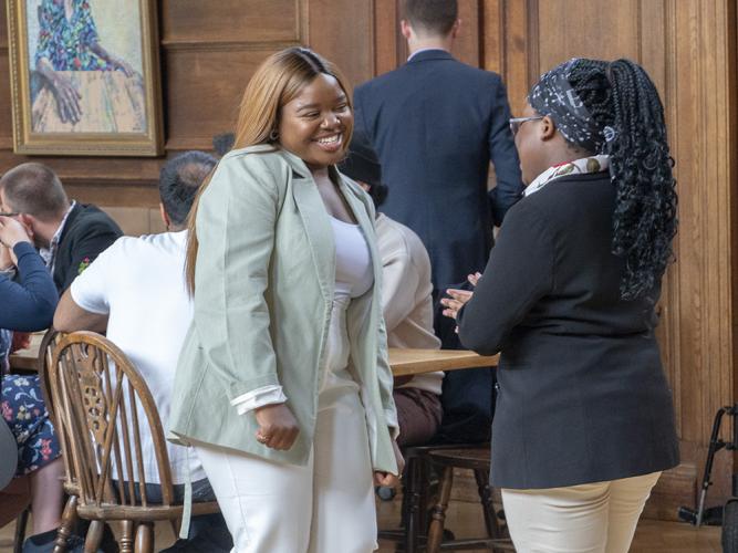 Vee Kativhu speaking with a Foundation Year student in Lady Margaret Hall Dining Hall